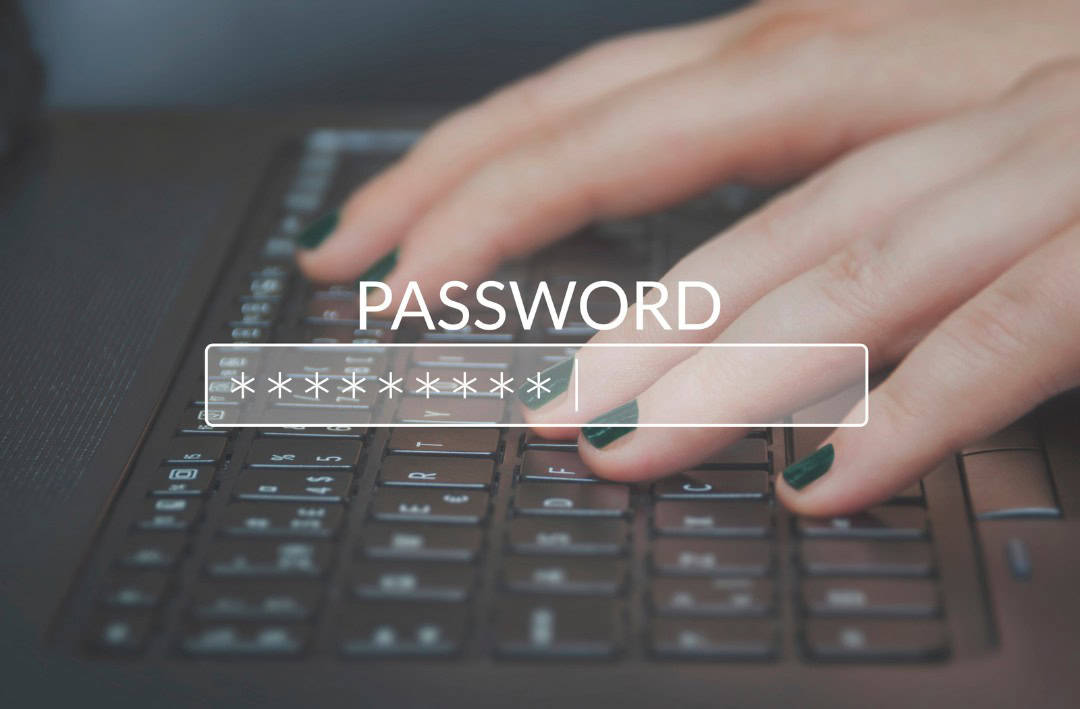 The work password in the foreground with a woman's hands typing on a keyboard in the background.